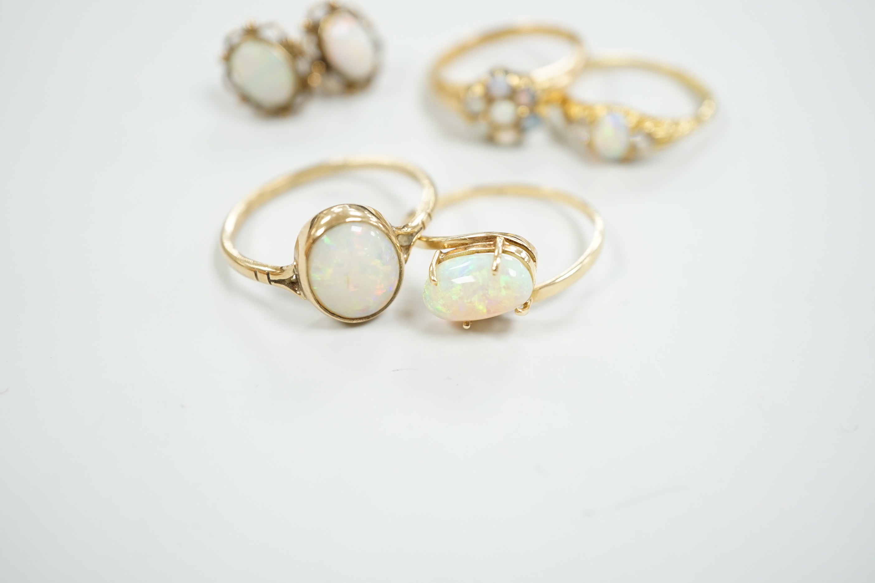 Two 18ct and white opal set rings, one with diamonds, gross 6.2 grams, a 14ct and white opal ring, a 9ct gold and white opal ring and a pair of 9ct gold and white opal earrings.